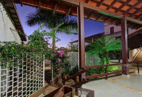 a patio with a white fence and some plants at Ecos Hotel Tourist in Rolim de Moura