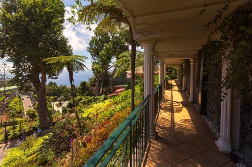 a balcony of a house with a view of the ocean at Quinta do Monte in Funchal