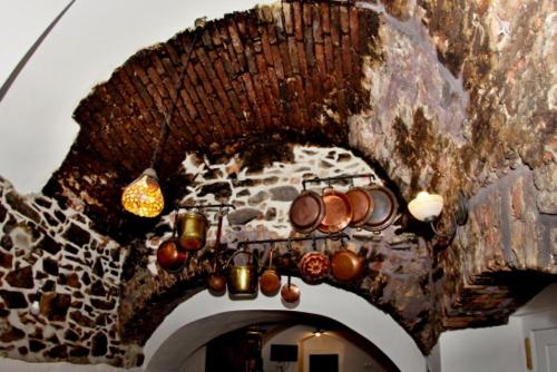 a stone archway with pots and candles on it at Penzion Kasper Cyklopenzion in Jindrichuv Hradec