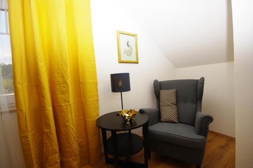 a room with a chair and a table and a window at Cozy Gardens Apartments in Prague in Prague