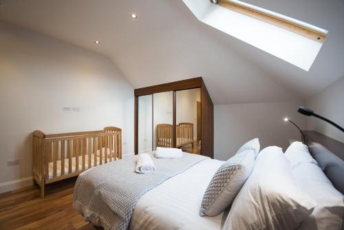 a bedroom with a large bed and a crib at Ocean Breeze in Portstewart