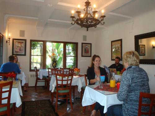 a group of people sitting at a table in a restaurant at The Eagle Inn in Santa Barbara