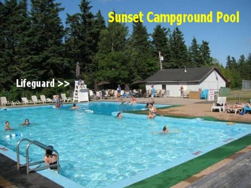a group of people swimming in a swimming pool at Boardwalk RV Rental (Site #14) in Cavendish
