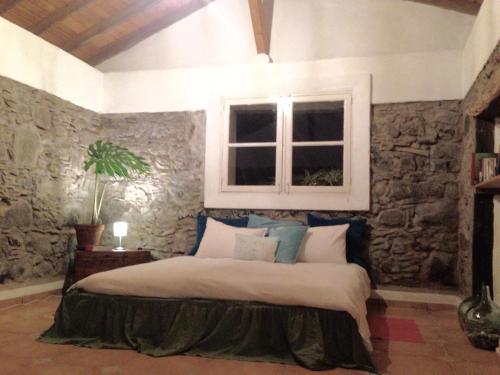 En eller flere senge i et værelse på Casa Aura