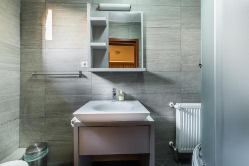 a bathroom with a sink and a mirror at Pensiunea Christiana in Arad