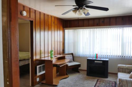 a living room with a desk and a ceiling fan at Mt Konocti View in Clearlake