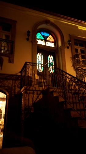 a building with a staircase and a stained glass window at CavlıHane 1885 in Ayvalık