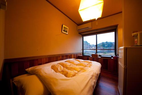 sypialnia z łóżkiem z chlebem w obiekcie Bansyou no Yu w mieście Taketa
