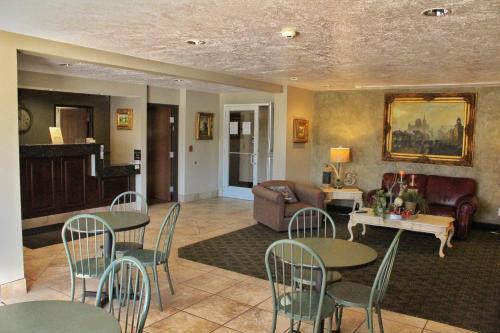 a living room with tables and chairs and a couch at Scipio Hotel in Scipio