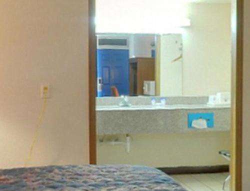 un baño con lavabo y espejo en Americas Best Value Inn Weatherford, en Weatherford