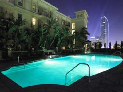a large blue swimming pool in front of a building at Top Floor 3 Bed 3 Bath Penthouse Living In Luxury in Los Angeles