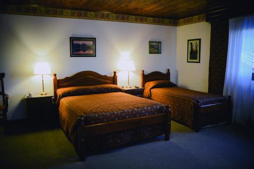 A bed or beds in a room at Posada Fueguina