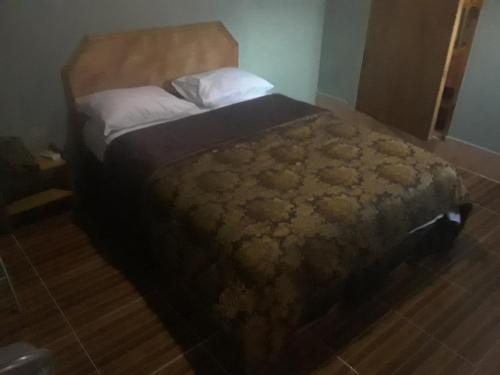 מיטה או מיטות בחדר ב-Pablo Guess House
