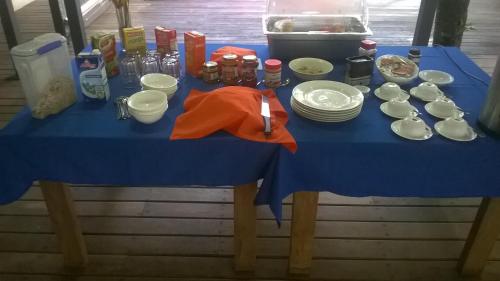a blue table with plates and utensils on it at Evis Resort at Nggatirana Island in Halisi