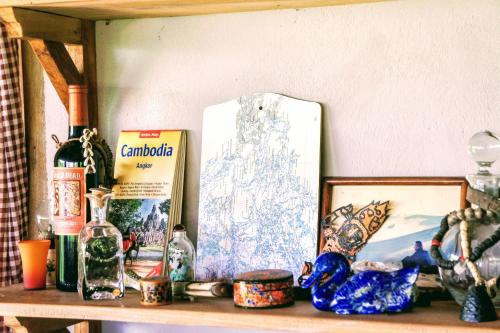 a shelf with a picture and other items on it at Khmer Hands in Kep