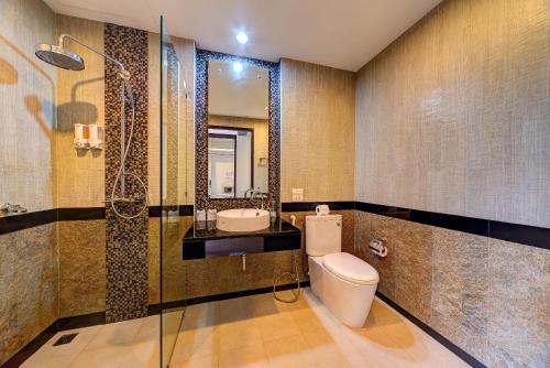 a bathroom with a toilet and a sink and a shower at Aonang Regent Hotel in Ao Nang Beach