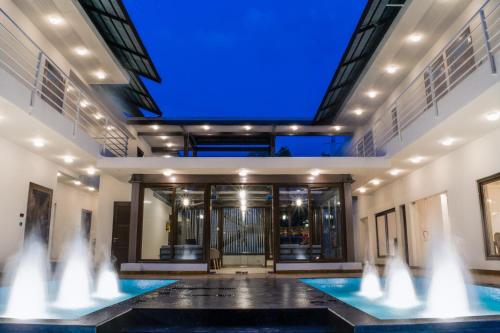a fountain in front of a building with a blue ceiling at The Ivy Anjuna in Anjuna