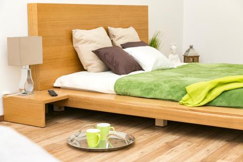 a bedroom with a wooden bed with a tray on it at Convenience & Chic by the Basilica in Budapest