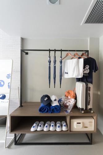 a shelf with umbrellas and other items in a room at Kokotel Krabi Oasis in Ao Nang Beach