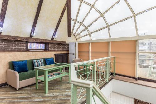 a living room with a couch and a table at Grand Sapphire Hotel in Almaty