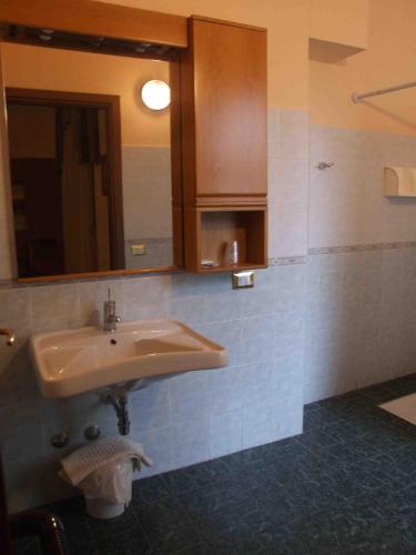 a bathroom with a sink and a mirror at Hotel Prestige in Montesilvano