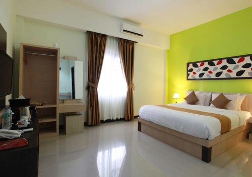 Un pat sau paturi într-o cameră la Green Tropical Village