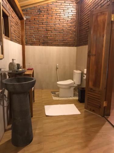 a bathroom with a sink and a toilet at Rumah Dharma 2 Riverside in Borobudur