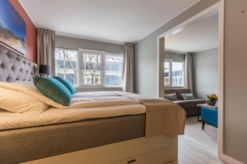 a bedroom with a large bed and a window at Radisson Blu Resort, Beitostølen in Beitostøl