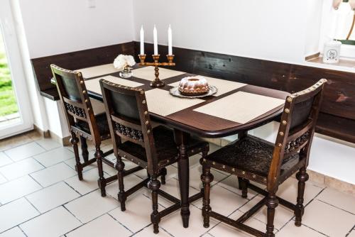 a dining room table with a cake on it at Chalupa Na Žofíně in Horní Podluží