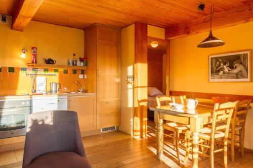 a kitchen and dining room with a table and chairs at Chalet Il fera beau demain in Villard-Reculas