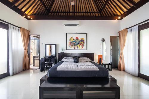 a bedroom with a large bed in a room at Villa L'Orange Bali in Keramas
