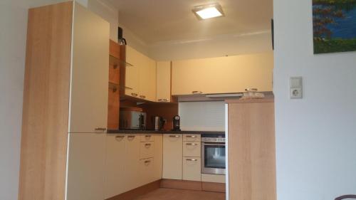 a kitchen with white cabinets and a stove top oven at Haus Walter in Filzmoos
