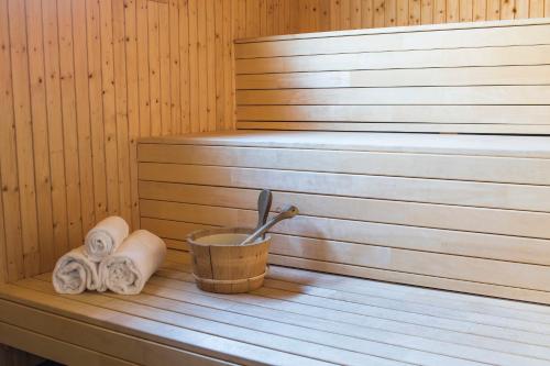 a sauna with towels and a bucket on a table at Hotell Frykenstrand; Sure Hotel Collection by Best Western in Sunne