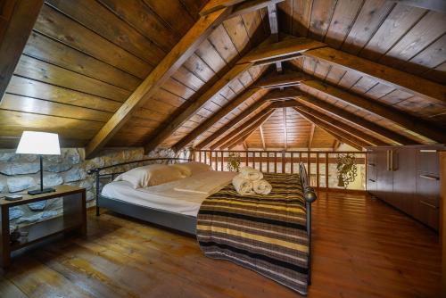 a bedroom with a bed in an attic at Abelos Villas in Áyios Ioánnis