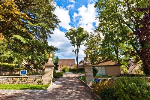 a walkway in front of a house with trees at Logis Hôtel Parenthèse, Restaurant & Spa in Chille