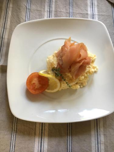 a plate of food with shrimp and a tomato at Badgers Hall in Chipping Campden