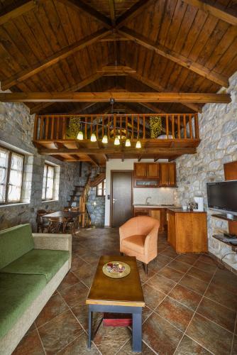 a living room with a couch and a table at Abelos Villas in Áyios Ioánnis
