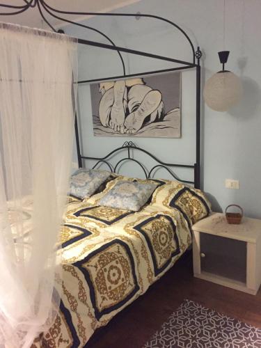 a bedroom with a bed with a black and gold comforter at la morra in Viterbo