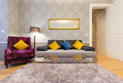 a living room with a couch and two tables at VotivPark Vienna Serviced Apartments in Vienna