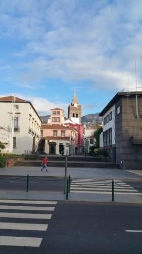 a person riding a skateboard down a city street at Edificio Charles 104 in Funchal