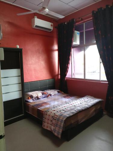 a bedroom with a bed with two dogs laying on it at Arau Guest House in Arau