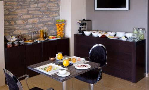 a table with plates of food on top at Hotel Minelska Resort in Kala Nera