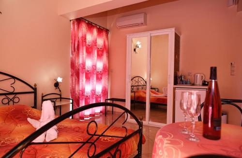 a bedroom with two beds and a table and a mirror at Akrogiali in Míloi