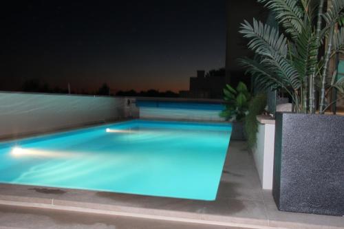 a swimming pool lit up at night on a building at Olive View in Vila Nova da Barquinha