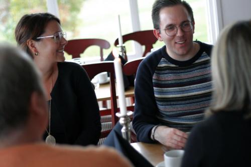 a man and woman sitting at a table talking at Hotell Frykenstrand; Sure Hotel Collection by Best Western in Sunne