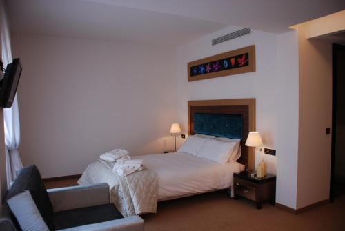 Ένα ή περισσότερα κρεβάτια σε δωμάτιο στο Dovitel Boutique Hotel 