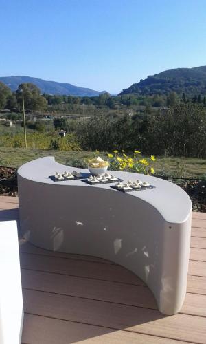 a white table with a bowl on top of it at Poggio di Sole in Lacona