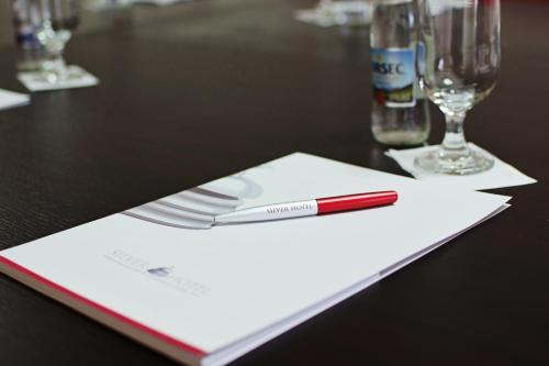 a red pen sitting on top of a table at Silver Hotel in Oradea
