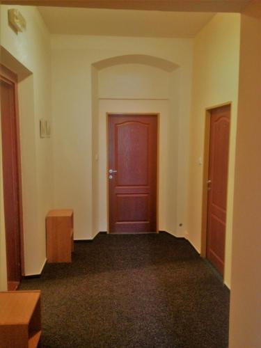 an empty room with a red door and two doors at Pension Žacléřský Medvěd in Žacléř