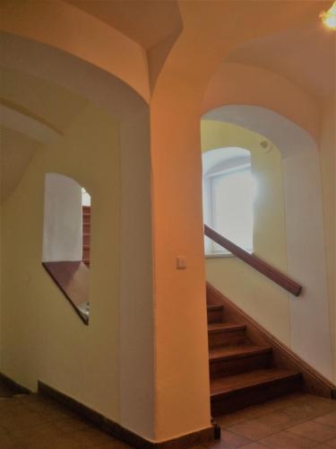 a hallway with arches and stairs in a building at Pension Žacléřský Medvěd in Žacléř
